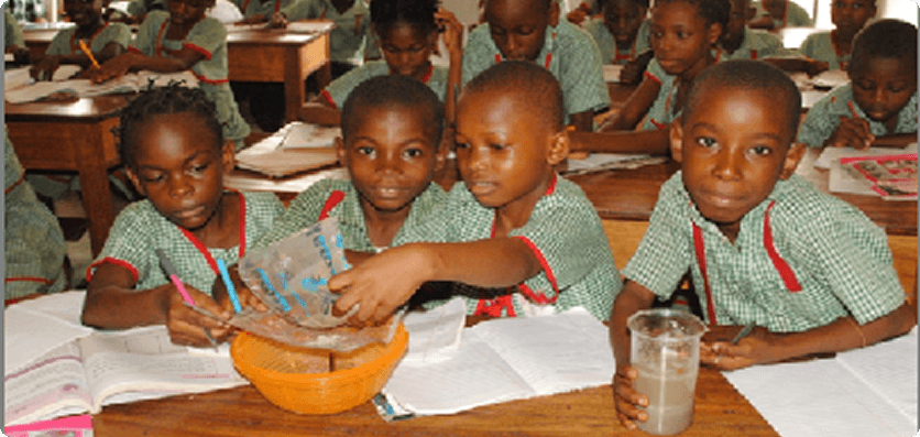Children at desks with school supplies